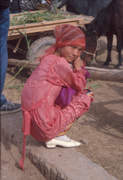 Young woman at animal market in Kasgar, China.